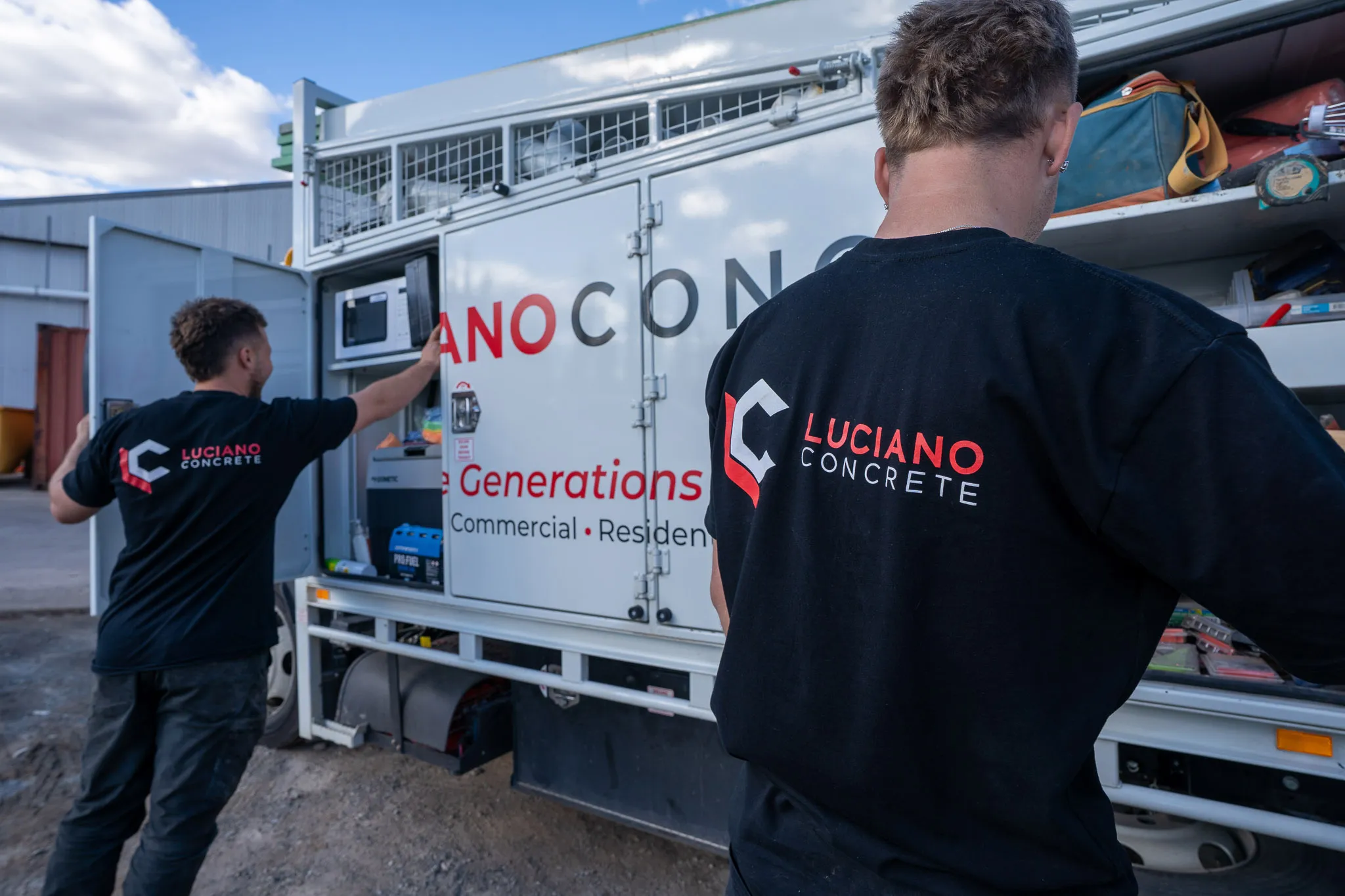 Luciano Concrete staff working on the side of their truck.