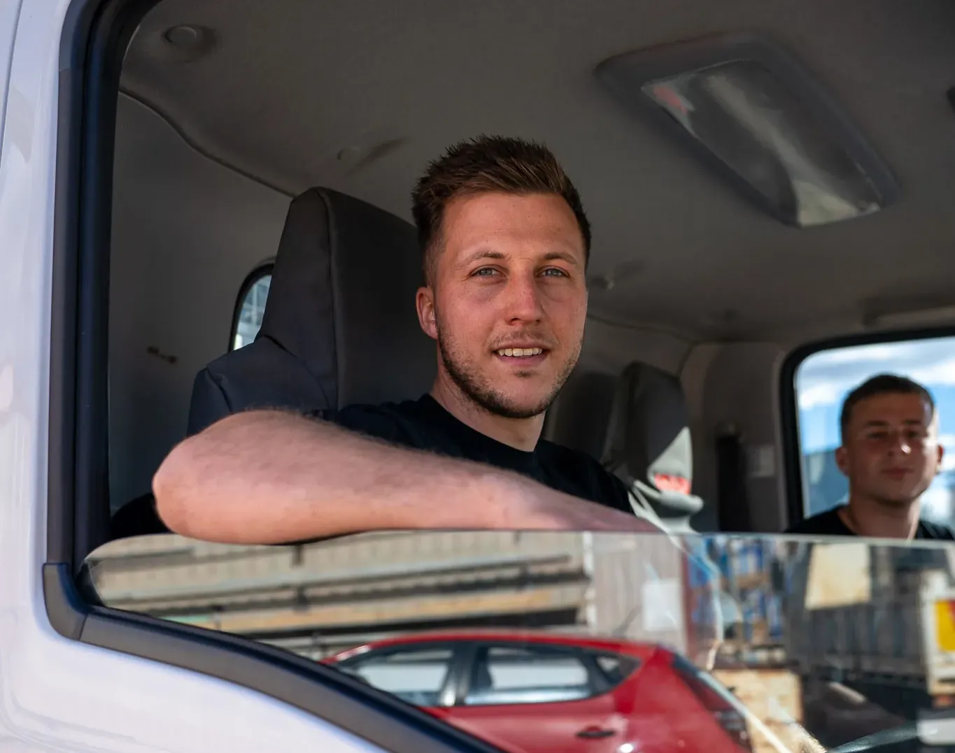 Luciano Concrete staff inside of truck looking at the camera.
