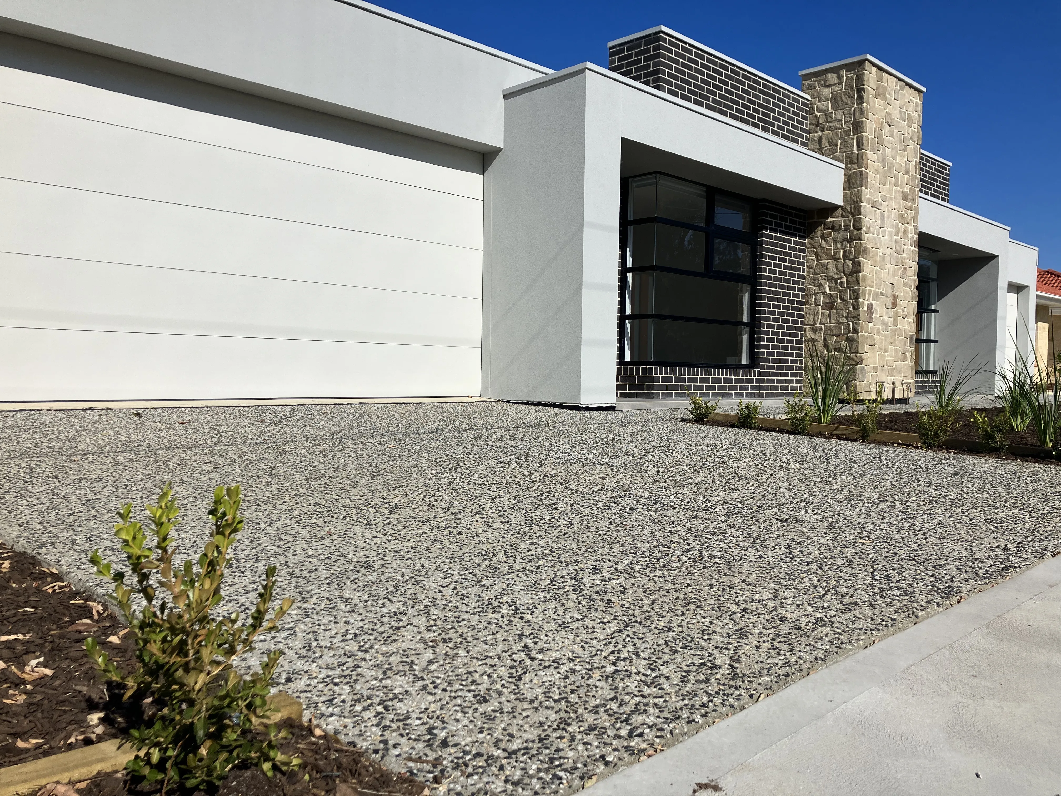 Exposed aggregate concrete used on a house driveway.